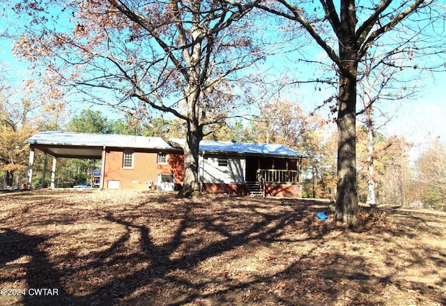 rear view of property with a carport