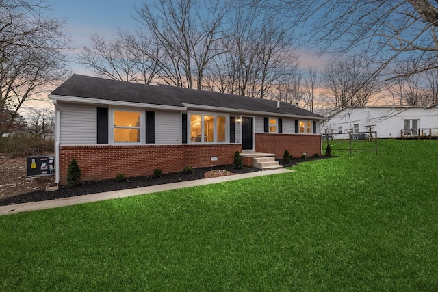 ranch-style house with a lawn