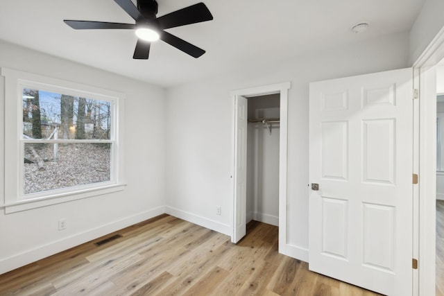 unfurnished bedroom with ceiling fan, a closet, and light hardwood / wood-style flooring