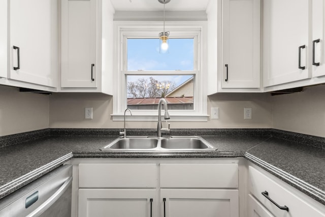 kitchen featuring white cabinets, stainless steel dishwasher, hanging light fixtures, and sink