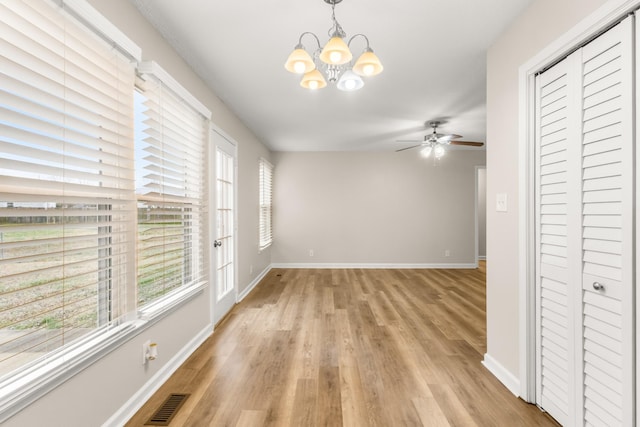 interior space with light hardwood / wood-style flooring and ceiling fan with notable chandelier