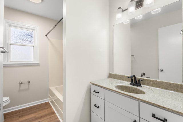 full bathroom featuring wood-type flooring, vanity, toilet, and shower / washtub combination