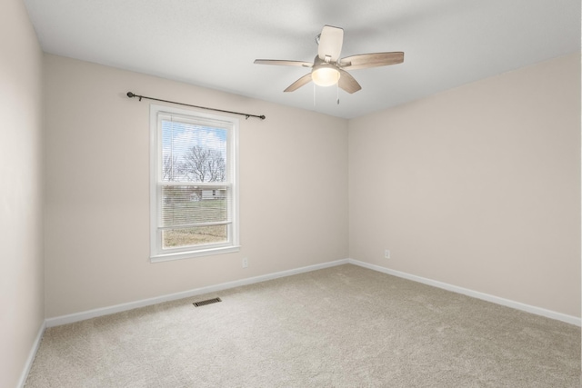 carpeted empty room featuring ceiling fan