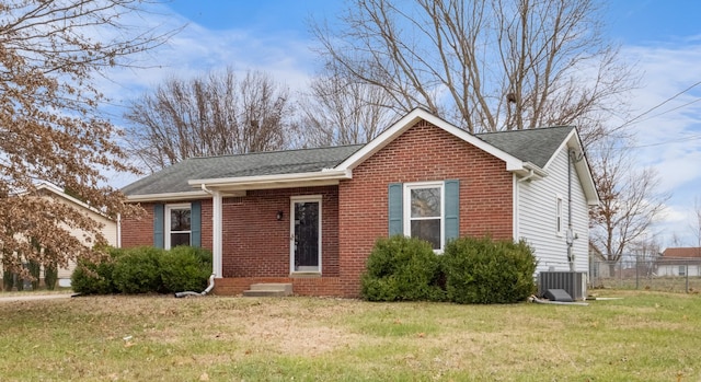 view of front of home featuring central air condition unit and a front yard