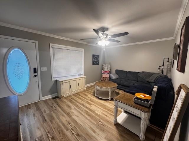 living room featuring crown molding, light hardwood / wood-style flooring, and ceiling fan