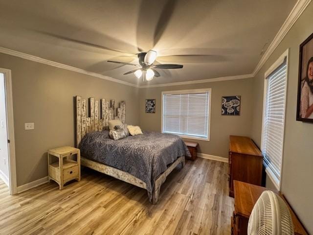 bedroom featuring light wood-type flooring, ceiling fan, and crown molding