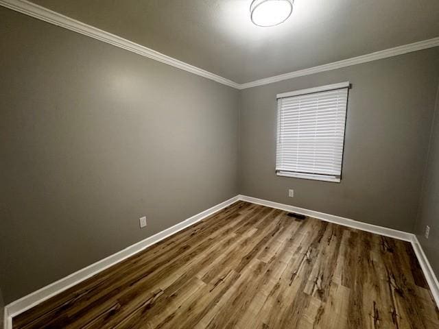 unfurnished room featuring hardwood / wood-style flooring and ornamental molding