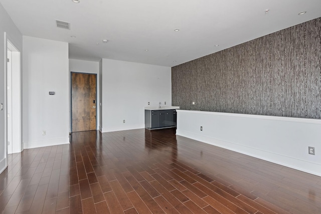 unfurnished room with sink and dark wood-type flooring