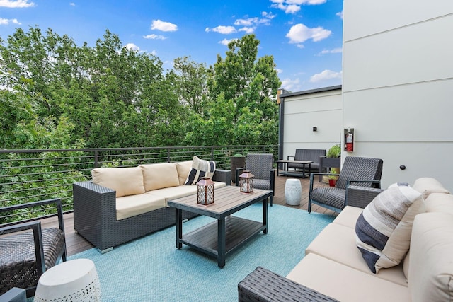 view of patio with an outdoor living space and a balcony