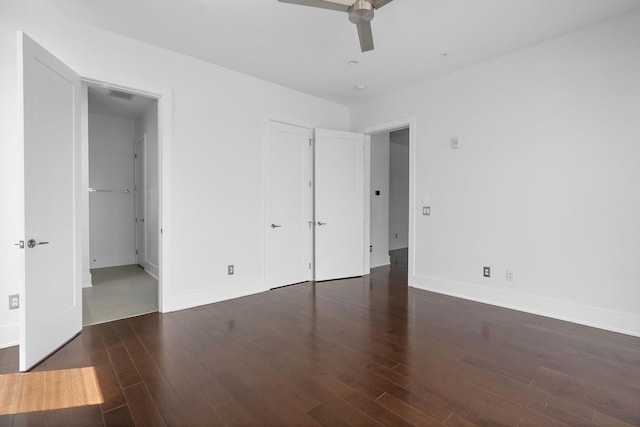 unfurnished bedroom featuring ceiling fan and dark wood-type flooring