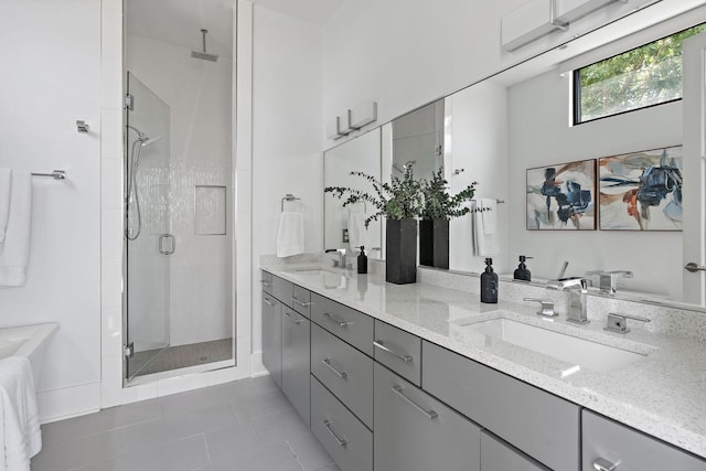 bathroom featuring tile patterned flooring, vanity, and walk in shower