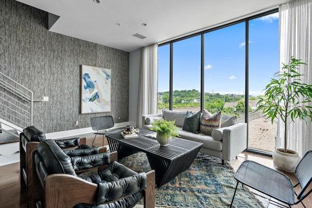 living room featuring wood-type flooring and floor to ceiling windows