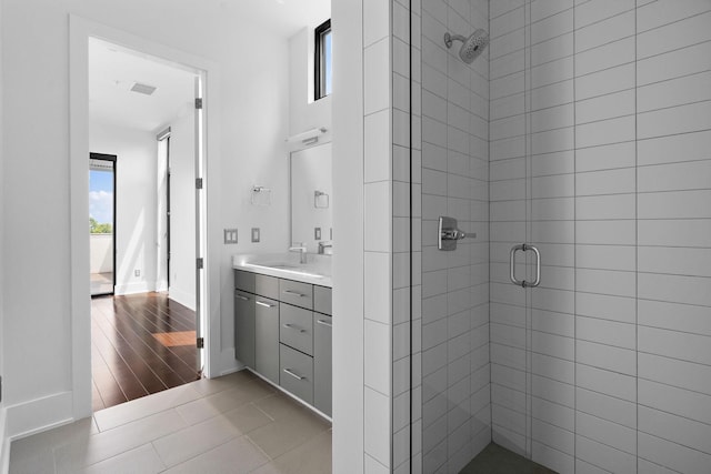 bathroom featuring tile patterned flooring, vanity, and an enclosed shower