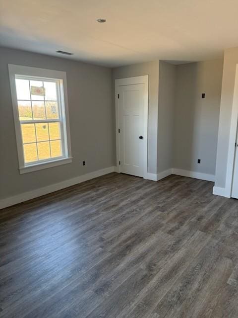 empty room with dark hardwood / wood-style floors