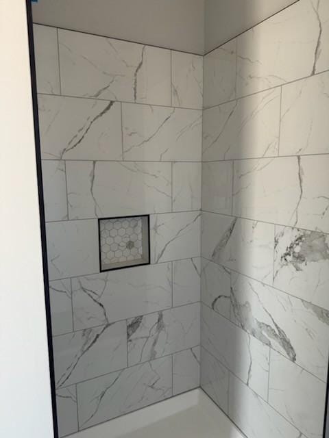 bathroom with tiled shower