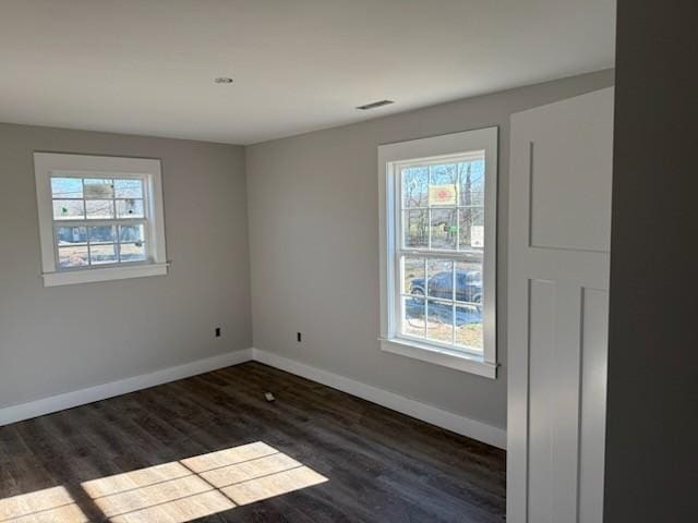 unfurnished room featuring dark hardwood / wood-style flooring