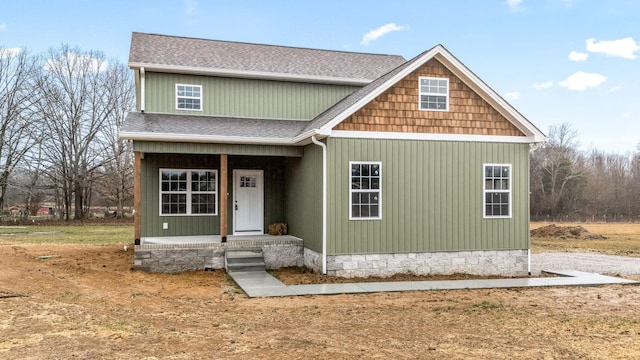 view of front of property with roof with shingles and a porch