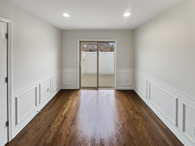 unfurnished room with dark hardwood / wood-style flooring