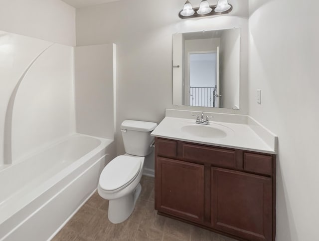 full bathroom featuring vanity, bathtub / shower combination, and toilet