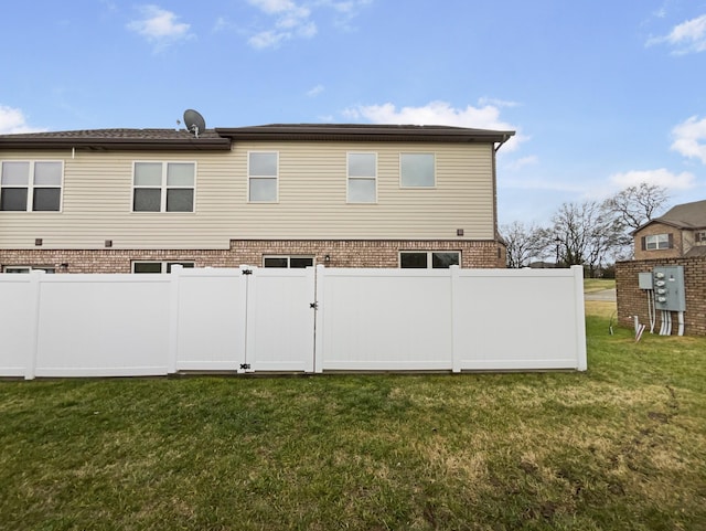 rear view of house with a yard