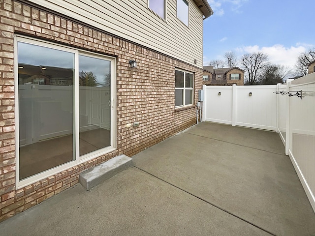 view of property exterior with a patio area