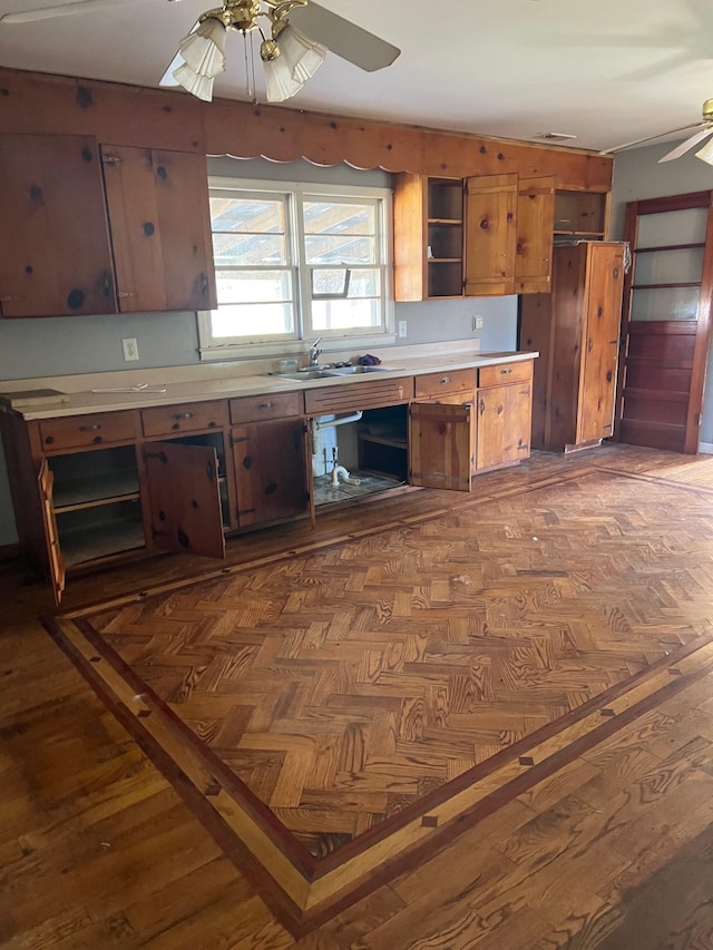 kitchen featuring ceiling fan, dark hardwood / wood-style floors, and sink