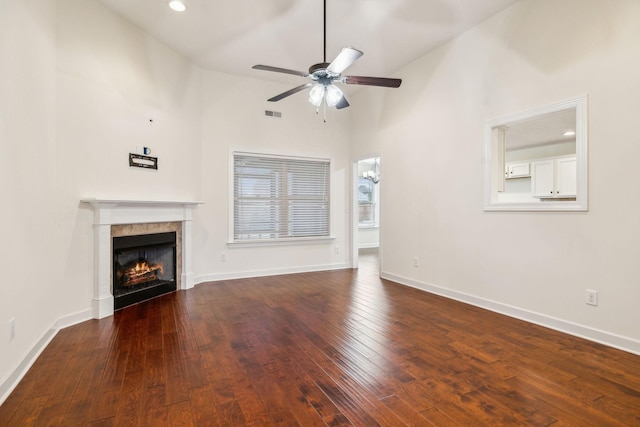 unfurnished living room with high vaulted ceiling, dark hardwood / wood-style floors, and ceiling fan