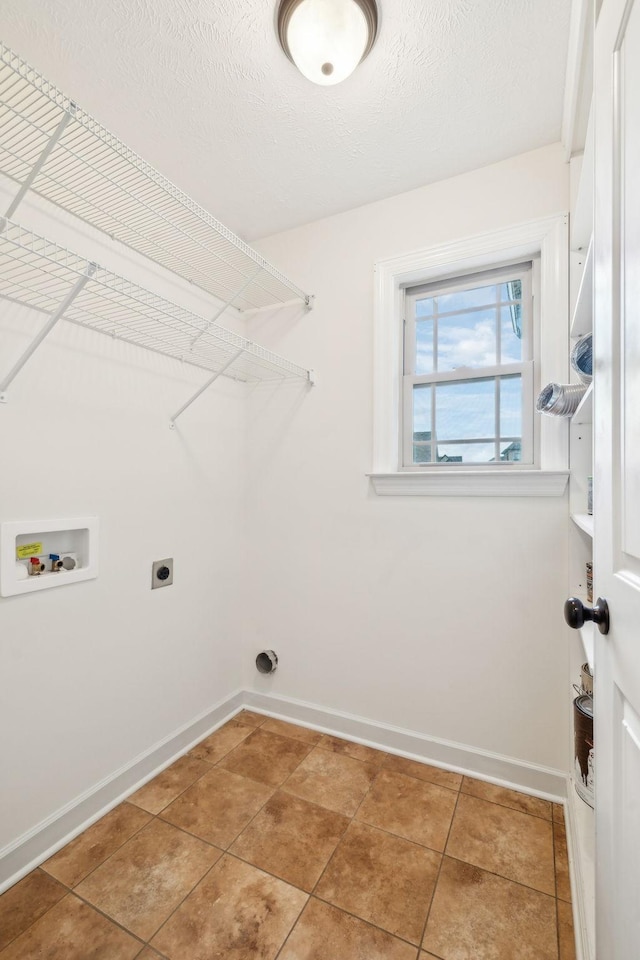 washroom with tile patterned floors, washer hookup, hookup for an electric dryer, and a textured ceiling