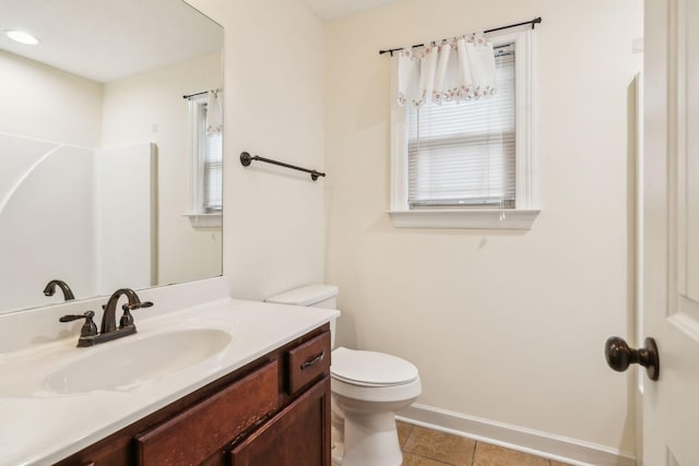 bathroom featuring vanity, tile patterned flooring, a shower, and toilet