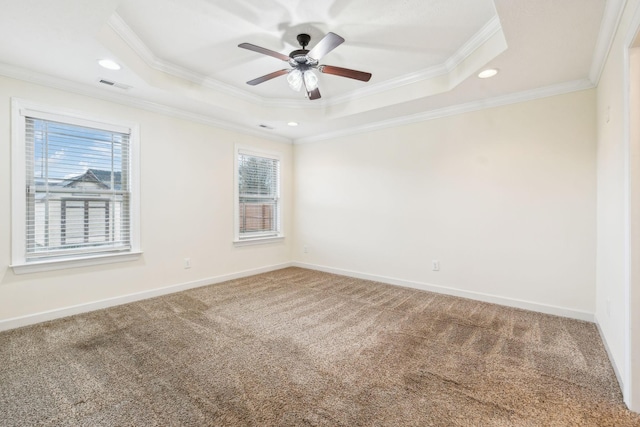 unfurnished room with ceiling fan, ornamental molding, a tray ceiling, and carpet floors