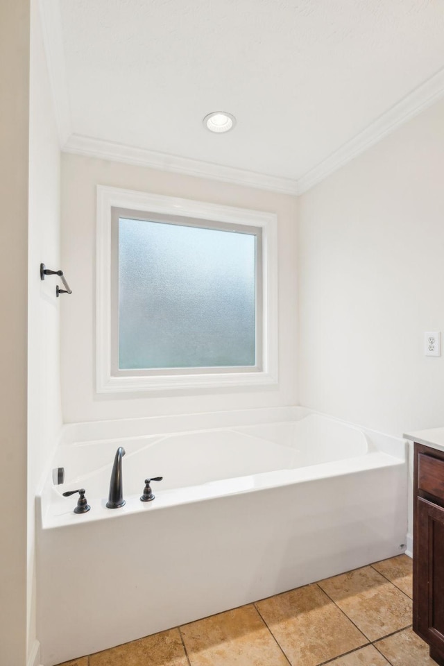 bathroom with crown molding, vanity, and a bathtub