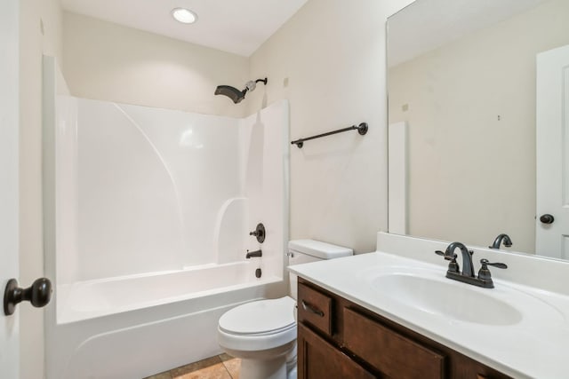 full bathroom with tile patterned floors, shower / washtub combination, toilet, and vanity