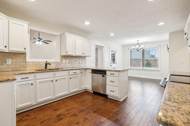 kitchen featuring dark wood-type flooring, stainless steel dishwasher, kitchen peninsula, and white cabinets