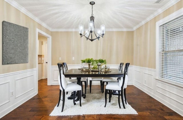 dining room with crown molding, dark hardwood / wood-style flooring, and an inviting chandelier