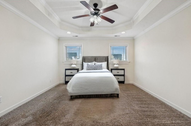 carpeted bedroom featuring ceiling fan, ornamental molding, and a raised ceiling