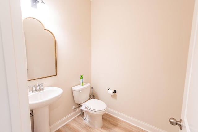 bathroom with sink, hardwood / wood-style floors, and toilet