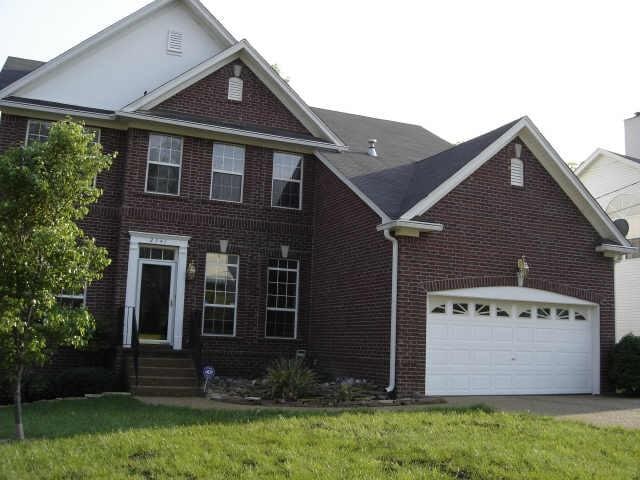 view of front of home with a garage and a front yard