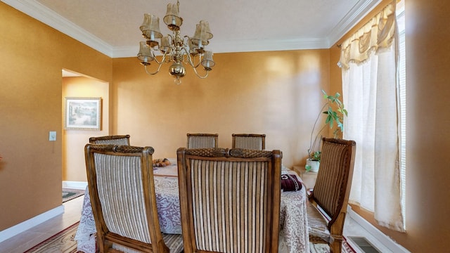 dining room featuring crown molding, tile patterned floors, and an inviting chandelier