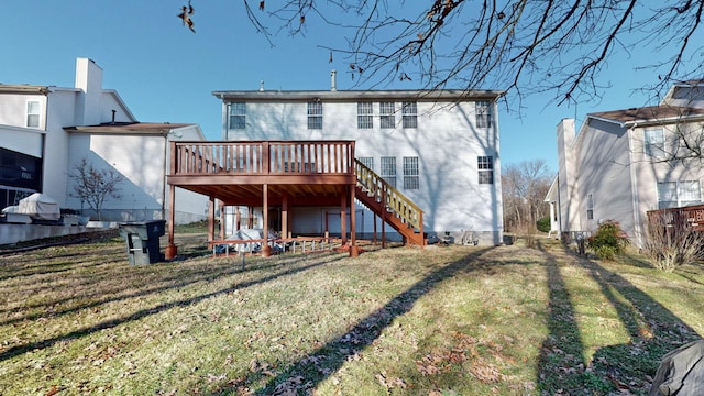 back of house featuring a wooden deck and a yard