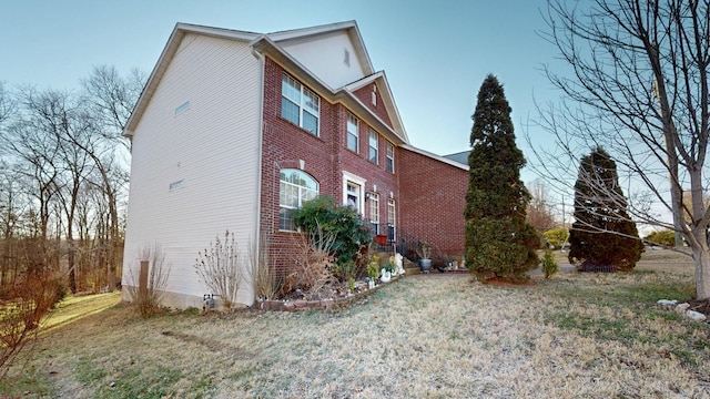 view of home's exterior with a lawn