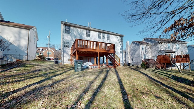 back of house featuring a yard and a deck