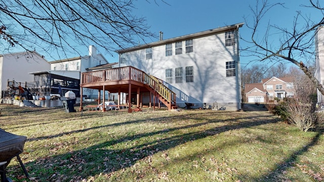 back of house featuring a deck and a lawn