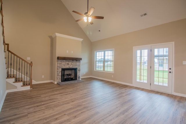 unfurnished living room with hardwood / wood-style flooring, ceiling fan, a fireplace, and high vaulted ceiling