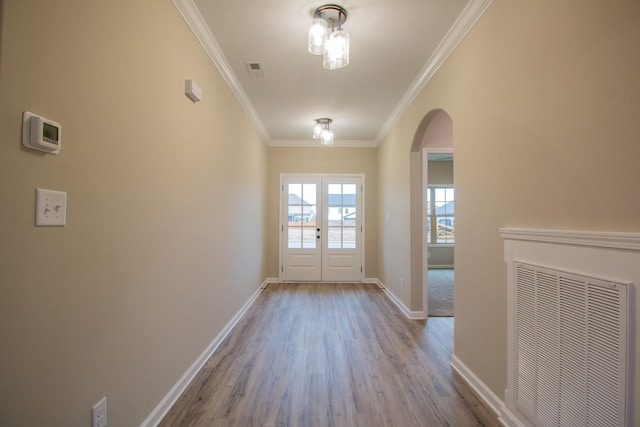 entryway featuring crown molding, french doors, and light hardwood / wood-style floors