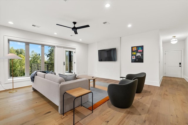 living room with ceiling fan and light hardwood / wood-style floors