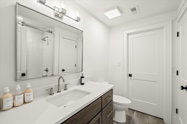 bathroom with a shower, vanity, and toilet