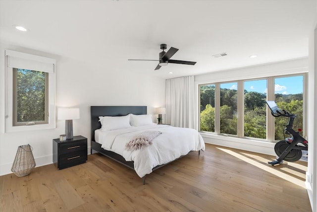 bedroom with ceiling fan and light hardwood / wood-style floors