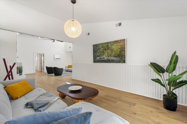 living room featuring light hardwood / wood-style flooring and vaulted ceiling