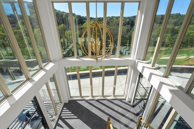 sunroom with a chandelier and a healthy amount of sunlight