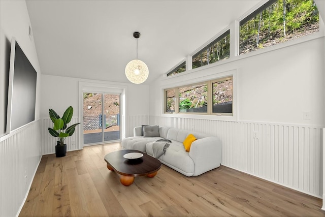 sitting room featuring vaulted ceiling and hardwood / wood-style flooring